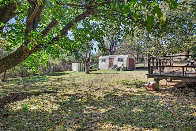 view of yard with a storage shed and a deck