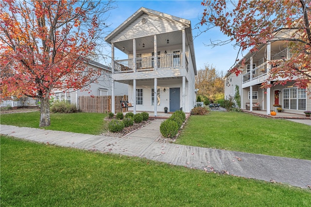 view of front of property with a balcony and a front yard