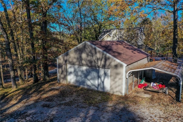 view of outbuilding with a carport and an outdoor structure