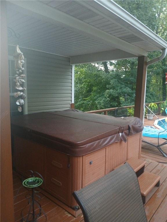 wooden deck with a hot tub