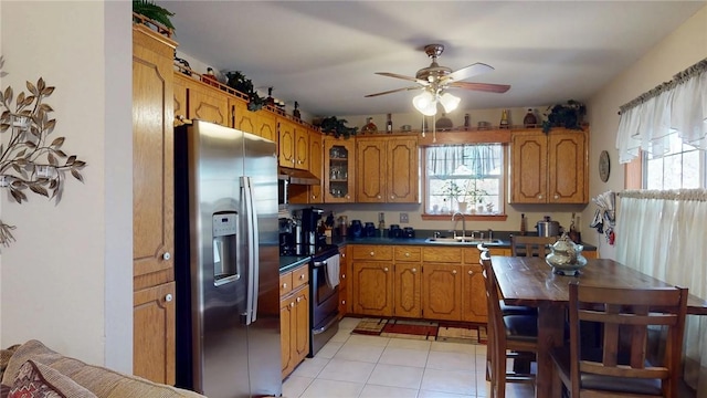 kitchen with a wealth of natural light, range with electric cooktop, a sink, and stainless steel fridge with ice dispenser