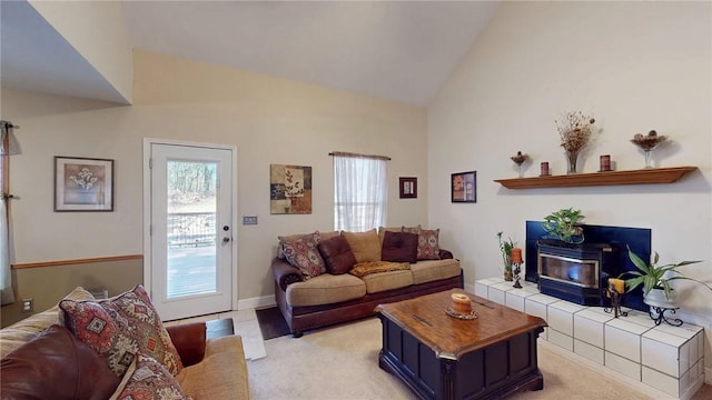 living area featuring high vaulted ceiling and light colored carpet