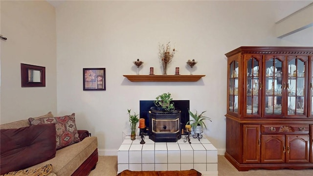 living room featuring a wood stove and baseboards