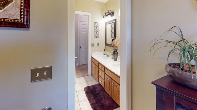 full bathroom with tile patterned flooring, a sink, and double vanity