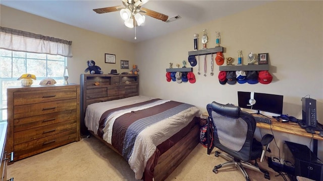 carpeted bedroom featuring a ceiling fan and visible vents