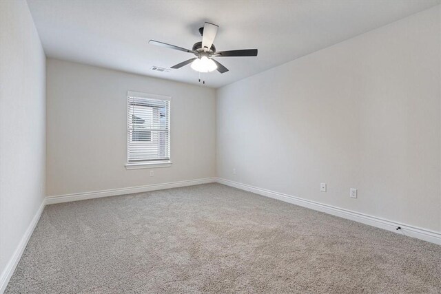 6602 SW Spindle St, Bentonville, AR 72713 - carpeted empty room with baseboards, visible vents, and a ceiling fan
