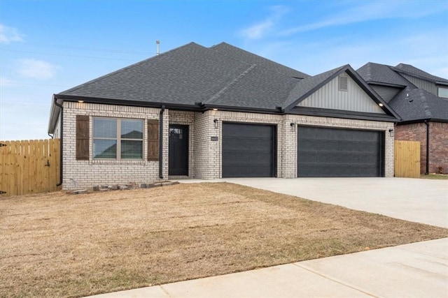 6602 SW Spindle St, Bentonville, AR 72713 - view of front of house featuring driveway, fence, an attached garage, brick siding, and a shingled roof