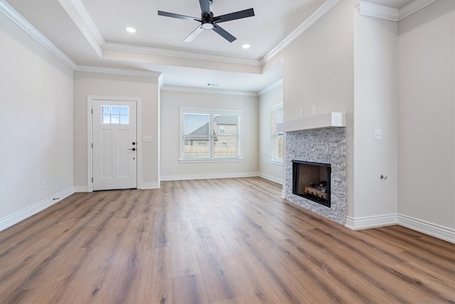 6602 SW Spindle St, Bentonville, AR 72713 - unfurnished living room with a raised ceiling, baseboards, ceiling fan, and wood finished floors