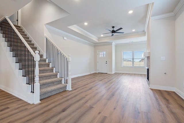 6602 SW Spindle St, Bentonville, AR 72713 - foyer entrance with a tray ceiling, stairs, ceiling fan, and wood finished floors