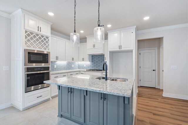 6602 SW Spindle St, Bentonville, AR 72713 - kitchen featuring white cabinets, crown molding, stainless steel appliances, tasteful backsplash, and a sink