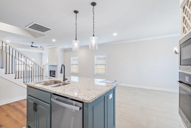 6602 SW Spindle St, Bentonville, AR 72713 - kitchen with visible vents, stainless steel appliances, a sink, open floor plan, and gray cabinetry