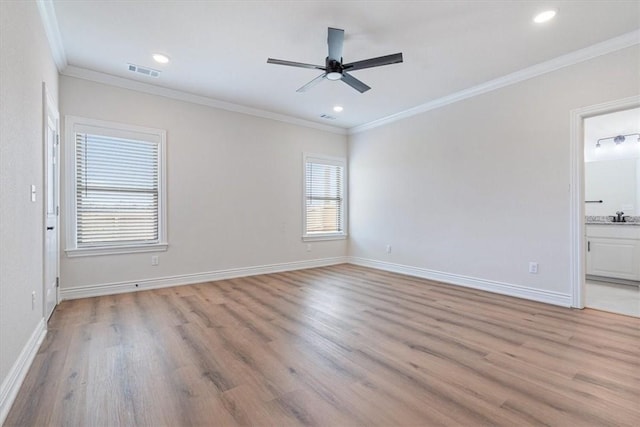 6602 SW Spindle St, Bentonville, AR 72713 - spare room with visible vents, crown molding, light wood finished floors, baseboards, and ceiling fan