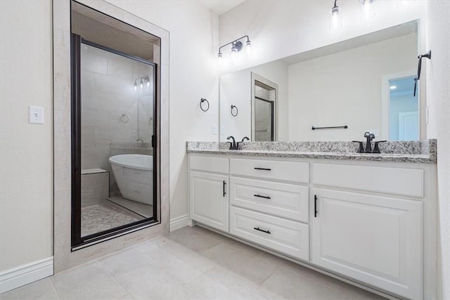 6602 SW Spindle St, Bentonville, AR 72713 - bathroom featuring tile patterned flooring, baseboards, a shower stall, a sink, and double vanity