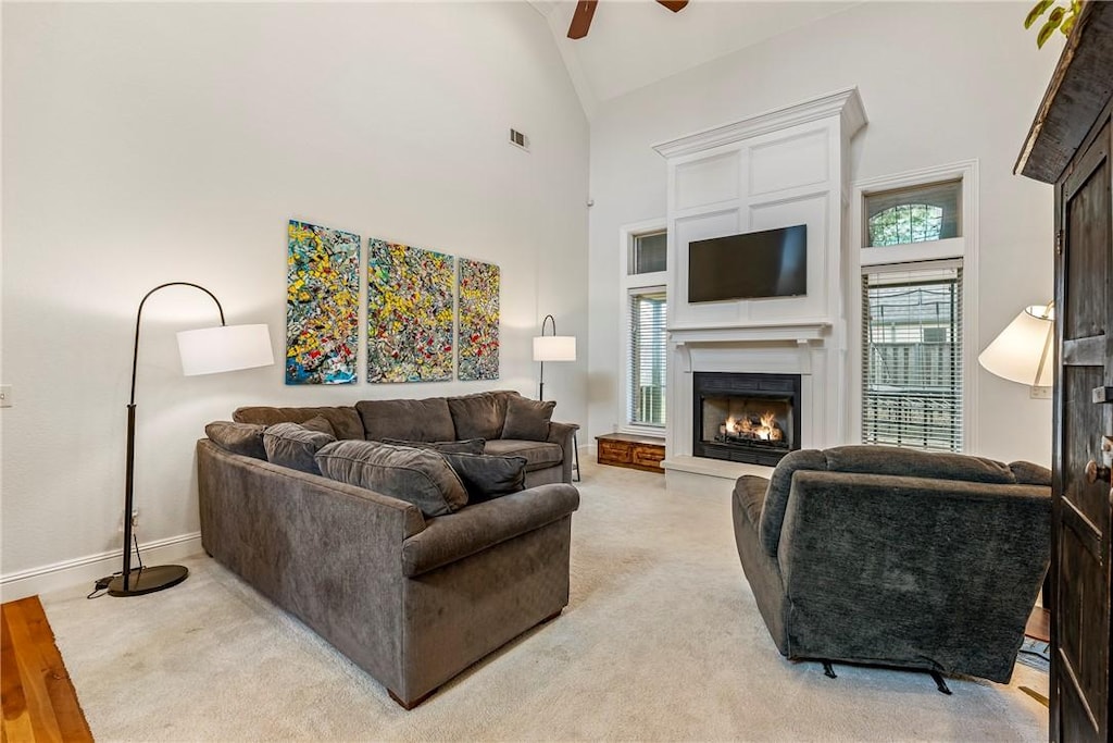 living room featuring ceiling fan and high vaulted ceiling