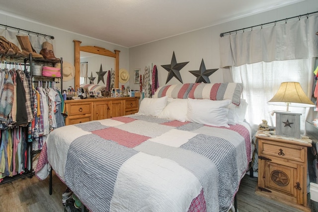 bedroom with dark wood-type flooring