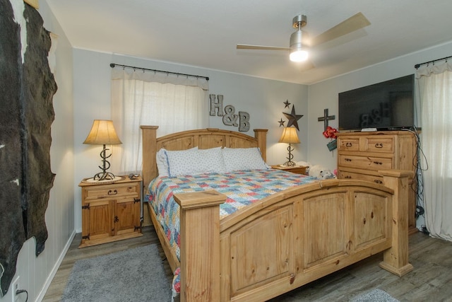 bedroom with ceiling fan and hardwood / wood-style flooring