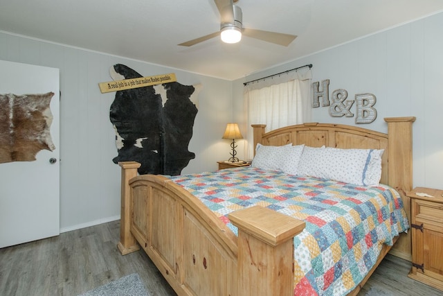 bedroom featuring wood walls, ceiling fan, and light hardwood / wood-style floors