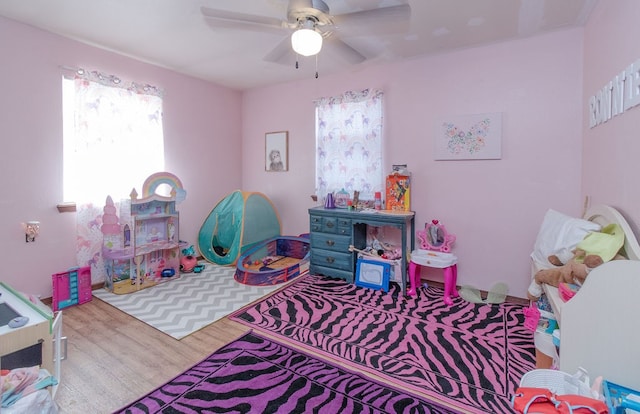 recreation room featuring hardwood / wood-style flooring and ceiling fan