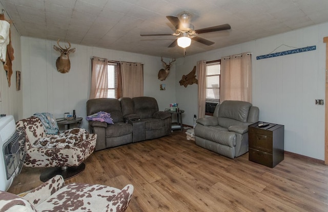 living room featuring hardwood / wood-style floors, ceiling fan, and a healthy amount of sunlight