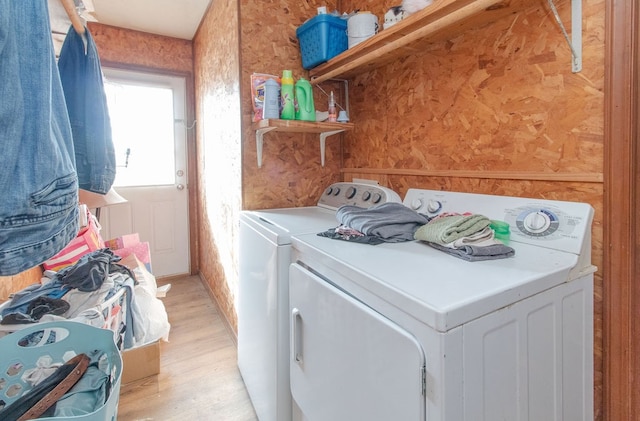 laundry area featuring washer and dryer and light hardwood / wood-style floors