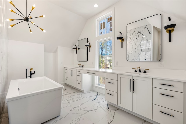 bathroom featuring vanity, a tub to relax in, lofted ceiling, and a notable chandelier