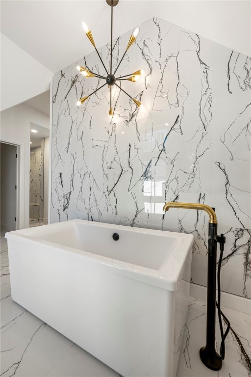 bathroom with a washtub and an inviting chandelier