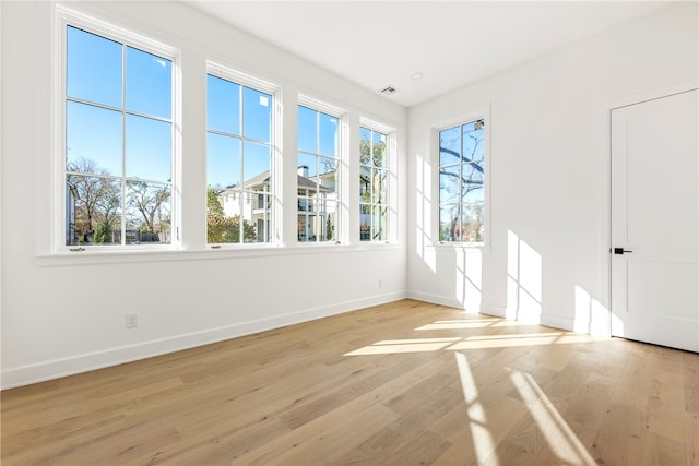 unfurnished room with light wood-type flooring