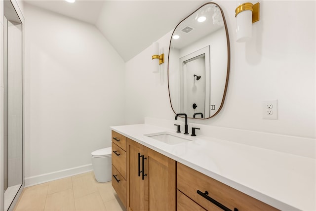 bathroom featuring tile patterned floors, walk in shower, vanity, vaulted ceiling, and toilet