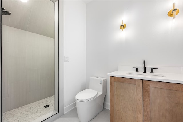 bathroom featuring tiled shower, tile patterned floors, vanity, and toilet