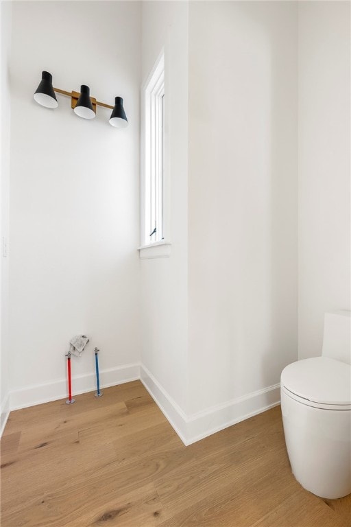 bathroom featuring hardwood / wood-style floors and toilet