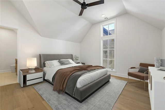 bedroom featuring hardwood / wood-style floors, vaulted ceiling, and ceiling fan