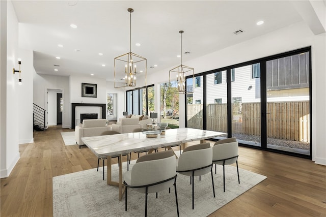 dining space with wood-type flooring