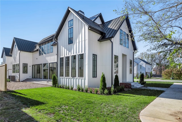 view of side of home featuring a lawn and central AC unit