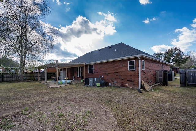 rear view of property featuring a yard and a patio area