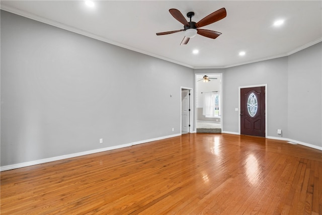 entryway featuring ceiling fan, light wood-type flooring, and ornamental molding