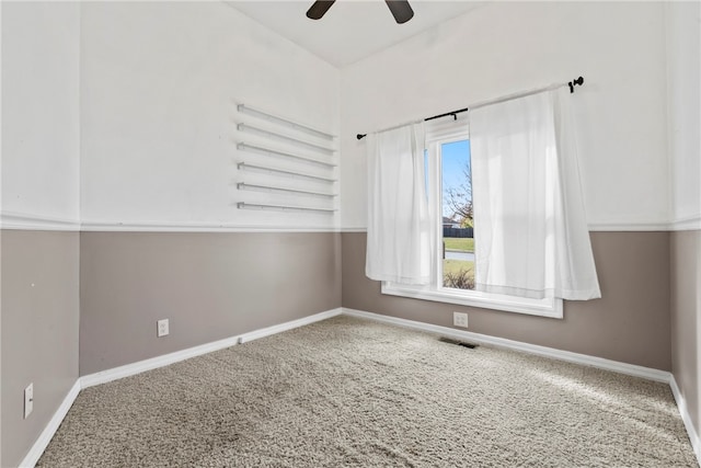 carpeted spare room with ceiling fan