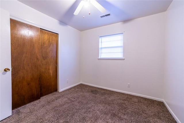 unfurnished bedroom with ceiling fan, a closet, and carpet