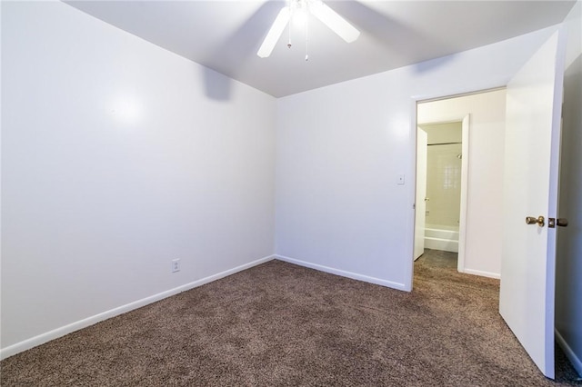 empty room with ceiling fan and dark carpet