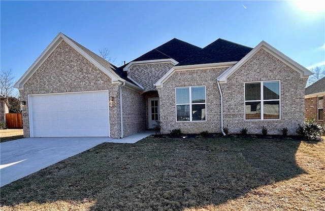 view of front of property with a front yard and a garage