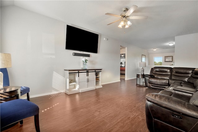 living room with ceiling fan, dark hardwood / wood-style flooring, and vaulted ceiling