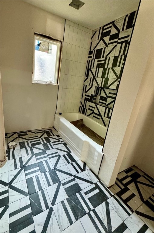 bathroom featuring tile patterned flooring and shower / bathing tub combination