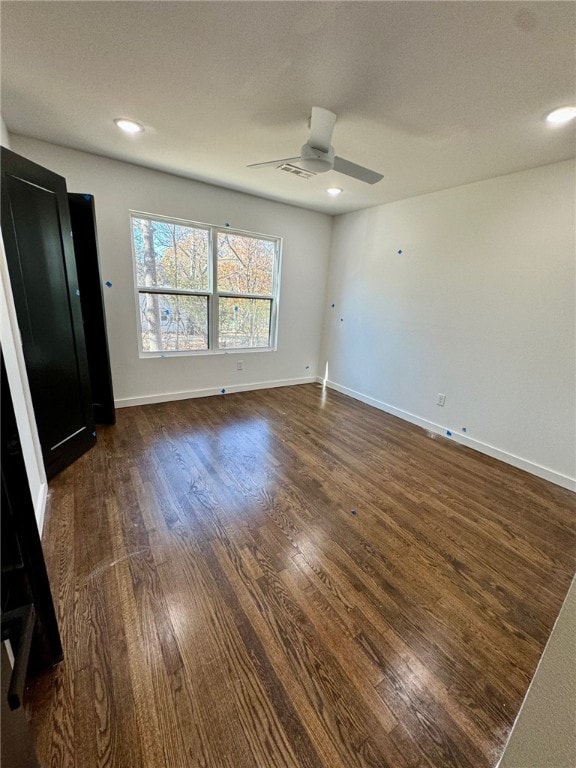 empty room featuring ceiling fan, dark hardwood / wood-style flooring, and a textured ceiling