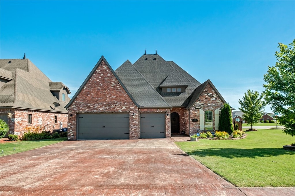 view of front of home with a garage and a front yard