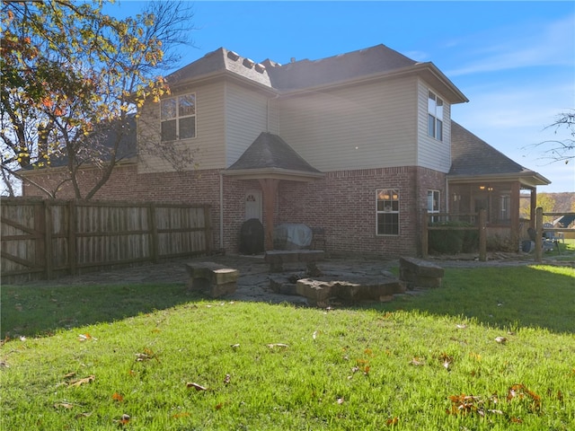 rear view of house featuring a lawn and a patio area