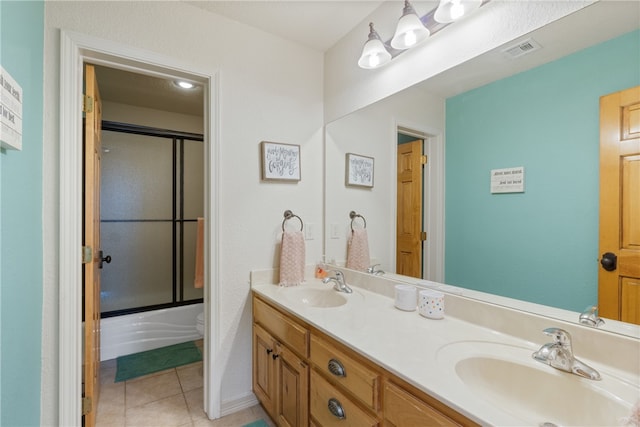 full bathroom with tile patterned flooring, vanity, toilet, and enclosed tub / shower combo