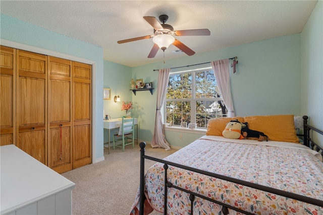 carpeted bedroom featuring a closet and ceiling fan