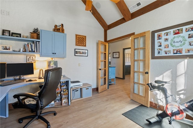 home office with vaulted ceiling with beams, french doors, and light hardwood / wood-style floors