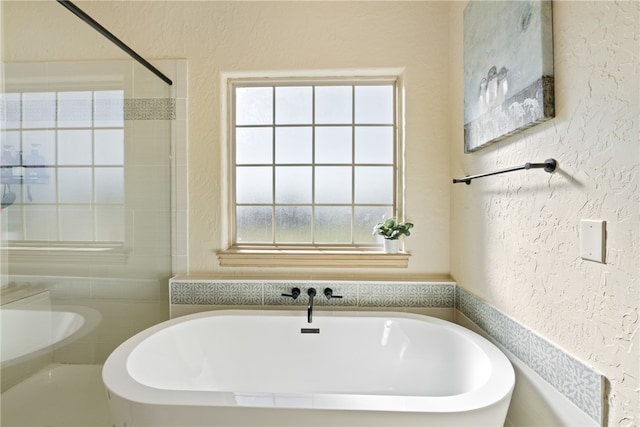 bathroom with a tub to relax in