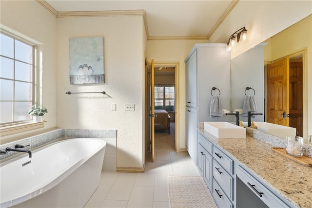 bathroom featuring tile patterned flooring, vanity, a healthy amount of sunlight, and ornamental molding