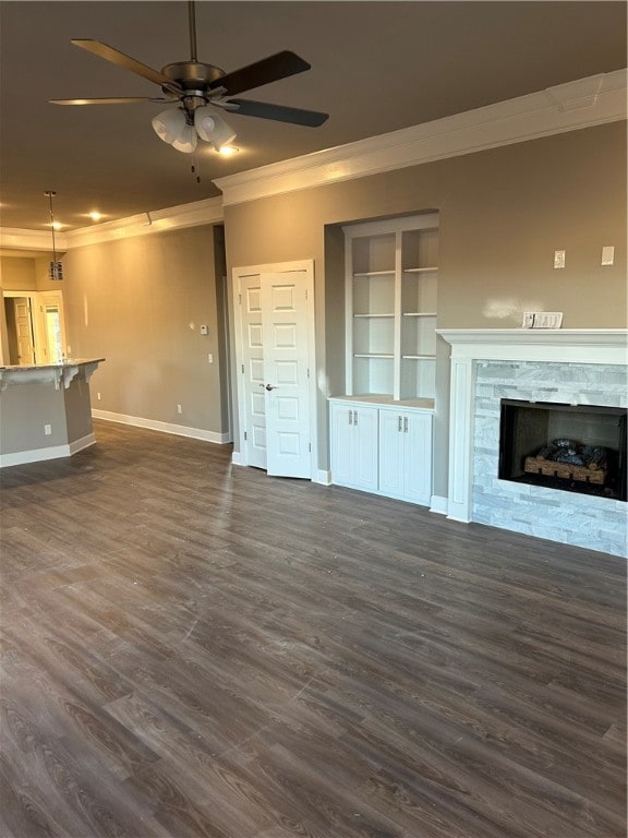 unfurnished living room with crown molding, dark hardwood / wood-style flooring, and ceiling fan